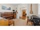 Cozy living room featuring a piano, guitars, and an open doorway leading to the dining area at 3269 Uinta St, Denver, CO 80238