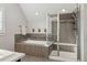 Bright bathroom featuring dual sinks, a glass enclosed shower, and a soaking tub at 3269 Uinta St, Denver, CO 80238