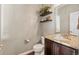 Charming powder room with granite counters, stylish shelving, and a decorative basket at 3269 Uinta St, Denver, CO 80238