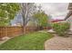 Large backyard with lush lawn, beautiful landscaping, and a stone-lined walkway at 9724 Crowsley Ct, Parker, CO 80134