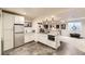 A finished basement bar area with sleek gray floors, beverage cooler, and granite countertop for entertaining at 9724 Crowsley Ct, Parker, CO 80134