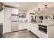 A finished basement bar with sleek gray floors, granite countertops, and a stainless steel refrigerator at 9724 Crowsley Ct, Parker, CO 80134