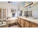 Bathroom featuring a large bathtub and shower combo, as well as a double vanity at 9724 Crowsley Ct, Parker, CO 80134