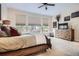Cozy bedroom showcasing a large bed, neutral carpet, and wood dresser near bright windows at 9724 Crowsley Ct, Parker, CO 80134