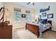 Comfortable bedroom with wood floors, a large window, and a dresser at 9724 Crowsley Ct, Parker, CO 80134