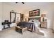 A well-lit bedroom showing an interesting side table made from a sewing machine and reflected barn door at 9724 Crowsley Ct, Parker, CO 80134