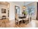 An elegant dining room boasting hardwood floors, a large window, and a sizable wooden table with seating for six at 9724 Crowsley Ct, Parker, CO 80134