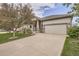 Home featuring a concrete driveway, well-maintained lawn, and manicured landscaping at 9724 Crowsley Ct, Parker, CO 80134