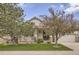 Home with well-manicured lawn and colorful landscaping. Note the charming front porch at 9724 Crowsley Ct, Parker, CO 80134