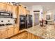Kitchen featuring stainless steel appliances, granite countertops, and wooden cabinets at 9724 Crowsley Ct, Parker, CO 80134