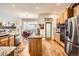 Kitchen featuring a center island, stainless steel appliances, and natural wood cabinets at 9724 Crowsley Ct, Parker, CO 80134