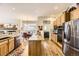 Bright kitchen with stainless steel appliances and an island that opens to the dining area at 9724 Crowsley Ct, Parker, CO 80134