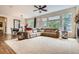 Open-concept living room featuring a ceiling fan, hardwood floors, and a dining area at 9724 Crowsley Ct, Parker, CO 80134