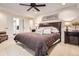 Comfortable main bedroom with a large bed, ceiling fan, and ensuite bathroom at 9724 Crowsley Ct, Parker, CO 80134