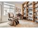 Home office features a massage chair, built-in bookshelves, and lots of natural light at 9724 Crowsley Ct, Parker, CO 80134