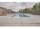 Outdoor community pool featuring lounge chairs and mature trees at 9724 Crowsley Ct, Parker, CO 80134