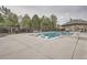 Outdoor community pool area with lounge chairs, landscaping, and trees surrounding at 9724 Crowsley Ct, Parker, CO 80134