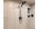 Shower featuring gray tiled walls, a shower head, and a built in storage niche at 9724 Crowsley Ct, Parker, CO 80134