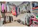 Large, organized walk-in closet with multiple clothing racks and shoe shelves at 9724 Crowsley Ct, Parker, CO 80134