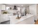 Modern kitchen island with white countertops and black accents at 5550 E Thrill Pl, Denver, CO 80207