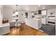 Modern kitchen with white cabinets, breakfast nook and stylish lighting at 5550 E Thrill Pl, Denver, CO 80207