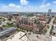 Expansive aerial view of the building and city skyline showcasing the surrounding cityscape under a bright, partly cloudy sky at 1499 Blake St # 3U, Denver, CO 80202
