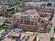 An aerial view showing the urban neighborhood of the residence with many brown brick buildings at 1499 Blake St # 3U, Denver, CO 80202