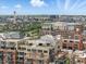 Scenic aerial shot highlighting the building's roof top amenities and views of the cityscape in the background at 1499 Blake St # 3U, Denver, CO 80202