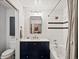 Stylish bathroom featuring a shower-over-tub, decorative mirror, and navy vanity at 1499 Blake St # 3U, Denver, CO 80202