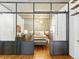 Serene bedroom with a glass wall, offering a view into the living area, complete with hardwood floors and modern lighting fixtures at 1499 Blake St # 3U, Denver, CO 80202