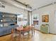 Well-lit dining room with modern chandelier, hardwood floors, and built-in storage at 1499 Blake St # 3U, Denver, CO 80202