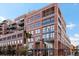 Attractive brick building with balconies and multiple windows on a sunny day, located on the corner of 15th Street and Palace Lofts at 1499 Blake St # 3U, Denver, CO 80202