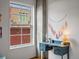 Bright home office featuring a vintage blue desk, wall decorations, and natural light from the large window at 1499 Blake St # 3U, Denver, CO 80202