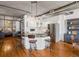 Modern kitchen with white cabinets, stainless appliances, island with barstool seating, and hardwood floors at 1499 Blake St # 3U, Denver, CO 80202