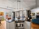 Contemporary kitchen with stainless steel oven, granite island, and hardwood floors at 1499 Blake St # 3U, Denver, CO 80202