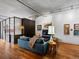 Bright living room offers an open concept with concrete ceilings and hardwood flooring at 1499 Blake St # 3U, Denver, CO 80202