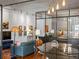 Spacious living area with hardwood floors, modern light fixture, glass wall, and comfortable furnishings at 1499 Blake St # 3U, Denver, CO 80202