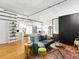 Cozy living room featuring hardwood floors, modern lighting, and a comfortable seating area with an open view to the kitchen at 1499 Blake St # 3U, Denver, CO 80202