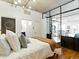 Spacious bedroom showcasing modern design, hardwood floors, and a view into the living space through the glass wall at 1499 Blake St # 3U, Denver, CO 80202