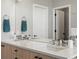 Bathroom features a double sink vanity with stone countertops and modern faucets at 5004 S Platte River Pkwy, Littleton, CO 80123