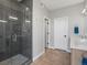 Modern bathroom with a glass enclosed shower and a double sink vanity with stone countertops at 5004 S Platte River Pkwy, Littleton, CO 80123