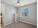 Bright bedroom featuring a ceiling fan, modern window, built in bookcase, and neutral color scheme at 5004 S Platte River Pkwy, Littleton, CO 80123