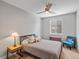 Cozy bedroom featuring neutral tones, comfortable bedding, a ceiling fan and natural light at 5004 S Platte River Pkwy, Littleton, CO 80123