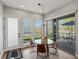 Inviting dining area with a glass table, views of the outdoor scenery, and ample natural light from large windows at 5004 S Platte River Pkwy, Littleton, CO 80123