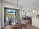 Bright dining area with sliding glass doors leading to a balcony, adjacent to the living room and kitchen at 5004 S Platte River Pkwy, Littleton, CO 80123