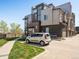 Modern townhome featuring sleek architectural design, a well-maintained lawn and convenient parking at 5004 S Platte River Pkwy, Littleton, CO 80123