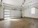 Spacious two car garage with white walls and a concrete floor, offering ample parking and storage at 5004 S Platte River Pkwy, Littleton, CO 80123