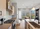 Modern kitchen with stainless steel appliances, light wood cabinets, hardwood floors and lots of natural light at 5004 S Platte River Pkwy, Littleton, CO 80123