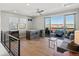 Stylish living room featuring a wet bar, modern ceiling fan, and a walkout terrace at 5004 S Platte River Pkwy, Littleton, CO 80123