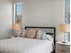 Close up of the bed in the main bedroom featuring side tables and a large window at 5004 S Platte River Pkwy, Littleton, CO 80123